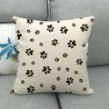 Linen cushion cover featuring black animal paw print patterns on a beige background - Animal Paw Prints / 45x45cm