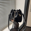 Glossy black drawstring bucket bag with pearl chain accents and silver hardware - Black