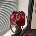 Fashionable red patent leather bucket bag with silver chain drawstring and pearl charms - Red
