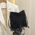 Chic black faux suede bucket bag featuring long fringe tassels and a minimalist strap - Black