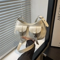 Minimalist beige moon bag in glossy faux leather with dual buckle pockets and wide strap - White