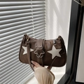 Dark brown leather underarm bag with white star patches and metallic buckle detail - Brown