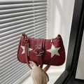 Chic burgundy star-patterned handbag with faux leather texture and metallic star clasp - Red