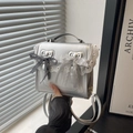 Silver flap backpack with lace trim and double bows, worn as a crossbody handbag - Silver