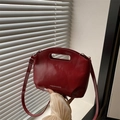 Minimalist red glossy bucket bag with top handle and shoulder strap for women - Red