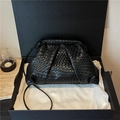 Elegant black woven cloud clutch bag on white silk dust cloth inside a gift box - Black