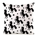 Detail of square cushion cover with black unicorn and star pattern on white faux silk fabric - Unicorn Repeat