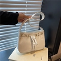 White glossy patent leather underarm bag with decorative drawstring and gold eyelets - White