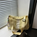 Sporty light yellow toast crossbody bag with white vertical stripes and purple charm detail - Yellow