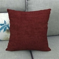 Close-up of dark red square cushion cover with textured linen fabric on a sofa - 45x45cm / Dark Red