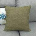 Olive green linen square throw pillow cover on a grey sofa with woven texture - 45x45cm / Grass Green