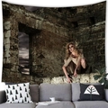 Dark gothic wall tapestry with ruins and woman motif above a grey fabric sofa - Woman in Ruins (1) / 150x100(Peach Skin)