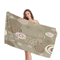 Olive green beach towel with geometric abstract patterns shown by a female model - Olive Geometric Abstract Pattern (1)