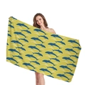 Bright yellow microfiber beach towel with seamless dolphin pattern held by a model - Yellow Dolphin Print(2) / 150x75cm