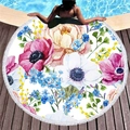 Round thick beach towel with tropical floral patterns and white tassels by the pool - Watercolor Floral Style