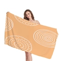 Bright orange beach towel with white geometric mandala patterns held by a model - Bright Orange Mandala Pattern (6)