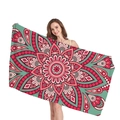 Ethnic mandala beach towel with red and turquoise geometric floral pattern held by model - Red Green Mandala (2)