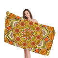 Bohemian mandala beach towel with bright geometric floral patterns held by a model - Orange And Green Mandala (4) / 150x75cm