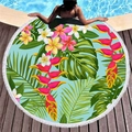 Tropical floral round beach towel with tassels and green leaf print on pool deck - Bird of Paradise Frangipani Style