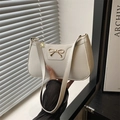Chic beige underarm baguette bag with golden bow and lychee leather texture - White