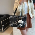 Black tote bag with wavy embroidery, textured fabric, and a cute cloud charm accessory - With Pendant / Black