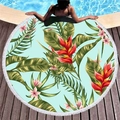 Tropical round beach towel with blue floral print and white tassel edge on wooden deck - Light Blue Base Red Tropical Floral (8)