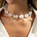Short beaded necklace with white marble resin beads and golden spacers on neck - Clear