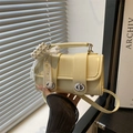 Fashionable light yellow handbag with pearl bow charm and silver twist locks for women - With Pendant / Yellow