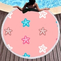 Round pink beach towel with blue starfish print and white tassels on a poolside wooden deck - Pink Starfish Print (7) / Diameter 150