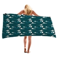 Thick Halloween beach towel with dark teal bat and wave pattern held by a model - Dark Teal Bat Waves (3)
