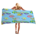 Thick microfiber beach towel with vibrant tropical fish and coral patterns on light blue - Colorful Tropical Fish School