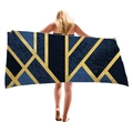 Large geometric beach towel with gold lines on dark blue, full display by model - Deep Blue Gold Lines (7)