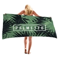 Tropical green palm leaf beach towel with PALMETTO print held by a female model - 150x75cm / Green Palm Palmetto Print (2)