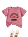 Detail of pink cotton baby t-shirt with baseball graphic and white bow shoes on top - 90cm / Peach