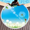 Blue circular beach towel with dandelion print and white tassel trim on wooden floor - Dandelion and Butterfly Print (4)