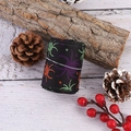 Close-up of Halloween ribbon with colorful spider patterns on black polyester fabric - Tri-color Spider Style / Black
