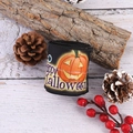 Halloween black ribbon roll with pumpkin patterns and Happy Halloween text on wood background - Poison Pumpkin Style / Black
