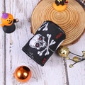 Close-up of Halloween ribbon roll featuring skull prints and red text on black fabric - Black Skull Style