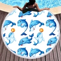 Round beach towel with blue dolphin patterns and white tassel fringe on a pool deck - Blue Cartoon Dolphin (3)