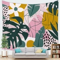 Tapisserie de feuilles tropicales artistiques accrochée au mur sur un canapé gris - Style Art Vitalité Mode (10)