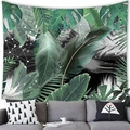 Tropical monstera leaf and geometric pattern wall tapestry in dark green over a gray sofa - 100x70cm / Peach Skin / Pattern 7