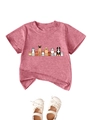 Flat lay of pink kids cotton T-shirt featuring cute cartoon dogs and Mary Jane shoes - 90cm / Peach