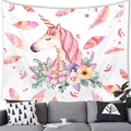 Detailed view of dreamy watercolor unicorn tapestry hanging above a modern sofa - 100x70cm / Peach Skin (Satin-like) / Sleeping Watercolor Unicorn (2)