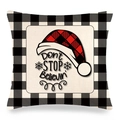 Detail of Christmas buffalo plaid pillow cover with red Santa hat and festive text - Christmas Hat Don't Stop Believin Style