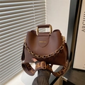 Dark brown bucket bag with gold handle and patterned strap for commute and casual wear - Brown