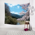 Detail of cherry blossom landscape tapestry hanging on a white brick wall in a cozy room - Cherry Stream Mountain (5)