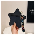 Detail of star-shaped crossbody bag featuring lychee texture leather and LOVE strap - Black