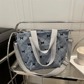 Light blue corduroy tote bag featuring black bow patterns and quilted rhombus embroidery - Blue