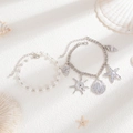 Detail of beach-style jewelry set with pearl beads, starfish and shell charms on sand - Double Layer Faux Pearl Metal Chain Style (06254) / Silver Tone (06254)
