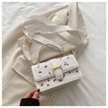 Detail of white PU leather crossbody bag with red cherry prints and golden hardware - White